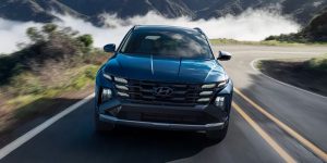 A 2025 Hyundai Tucson driving down a road in cloudy weather conditions near Rocky Mount, NC