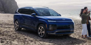 Two people standing next to a 2026 Hyundai IONIQ 9 on a beach near Rocky Mount, NC