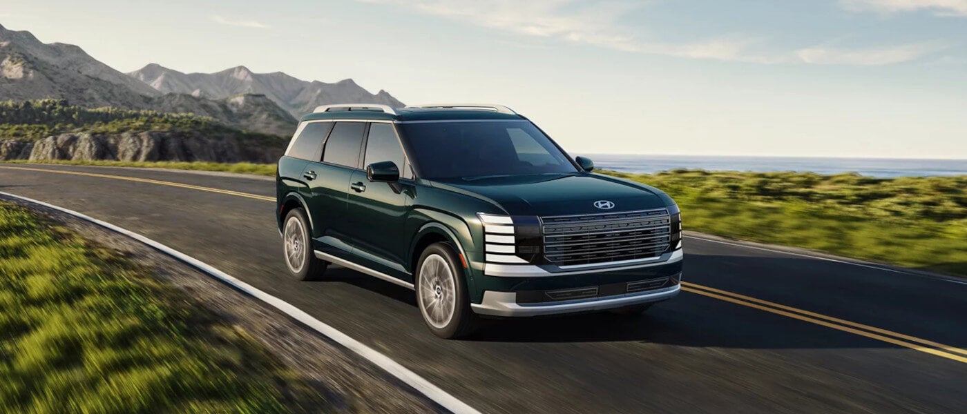 2026 Hyundai Palisade driving by lake and mountains